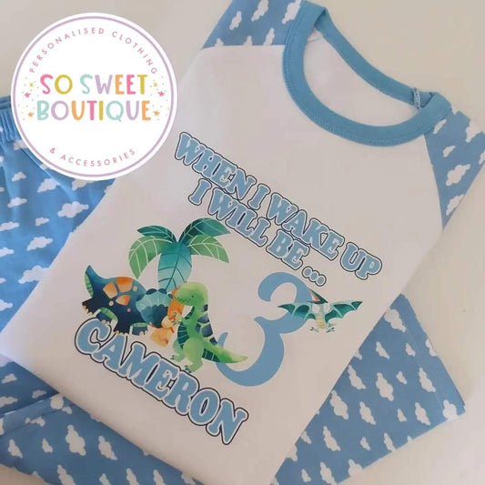 Personalised dinosaur birthday pyjamas for kids with colorful dinosaur illustrations, comfortable cotton fabric, and custom name option.