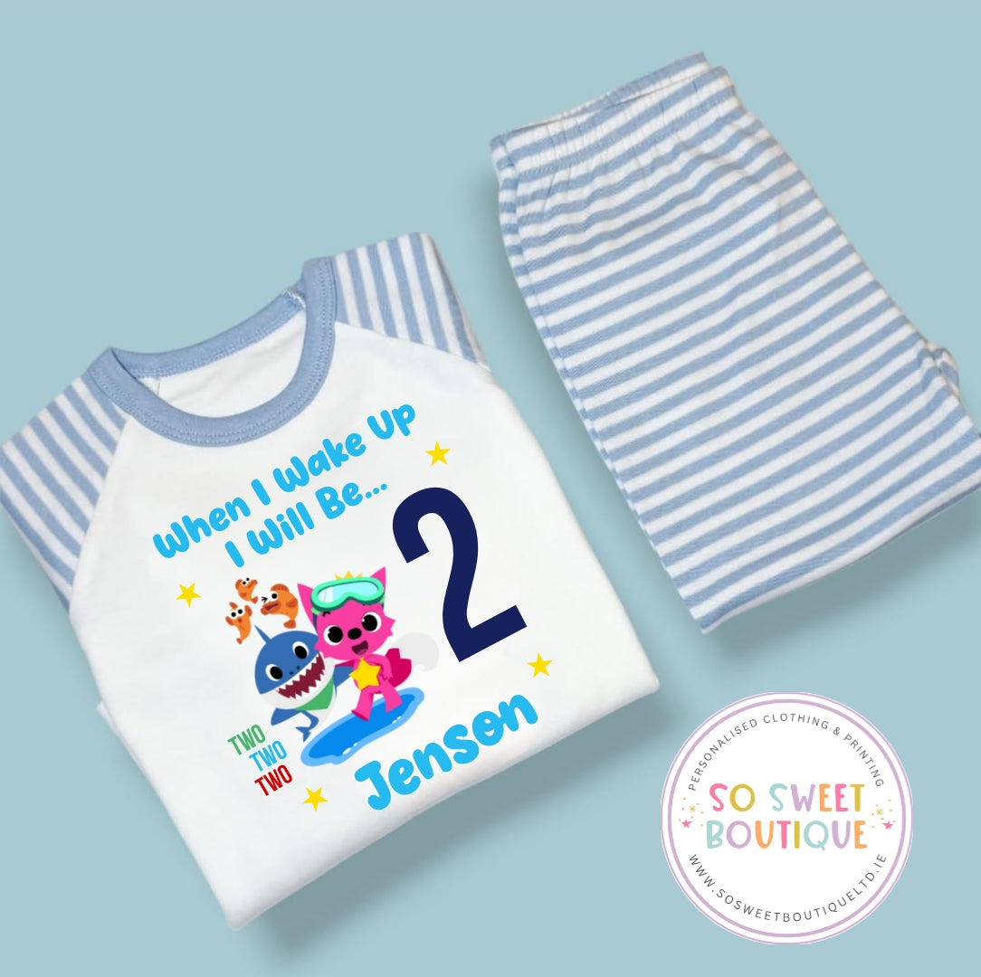 Personalised Baby Shark birthday pyjamas for kids, featuring bright colors and fun shark designs from SoSweetBoutiqueLtd.