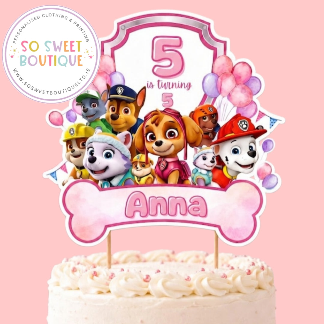 Pink Paw Patrol birthday cake topper with personalized message, featuring Paw Patrol characters and decorative elements for kids' celebrations.