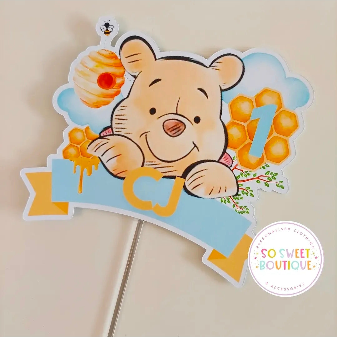 Personalized Winnie the Pooh birthday cake topper by SoSweetBoutiqueLtd featuring Winnie the Pooh figure and decorative elements.
