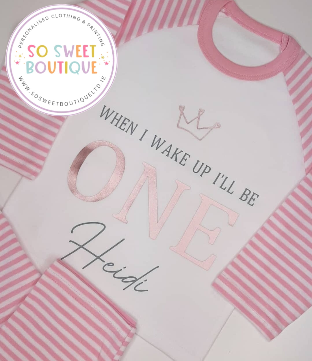 Pink crown style personalized birthday pyjamas for babies, featuring pink and white design, from SoSweetBoutiqueLtd.